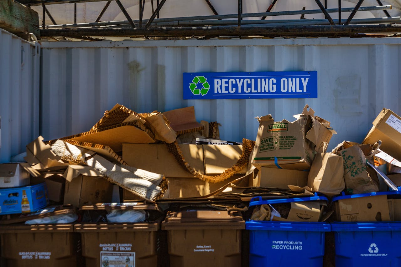 our-experience Recycling area filled with cardboard and paper materials, promoting sustainability.